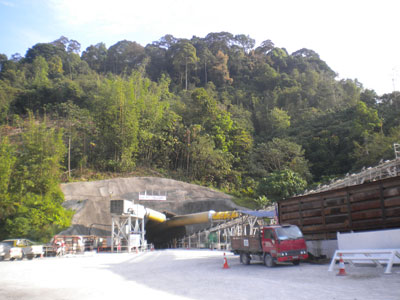 Tunnel-access adit beneath the rising overburden