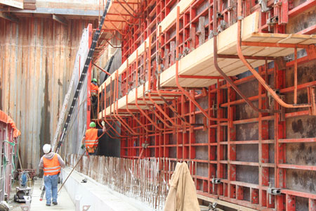 Formwork and reinforcement installation for the cut-and-cover construction within the permanent sheet piles